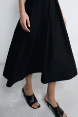 Vestido midi de Zara Woman Collection confeccionado en popelín de algodón. Presenta cuello redondo, manga corta y detalle de pliegues en la cintura que dan paso a una falda con caída evasé. Cierre posterior con abertura y botón.