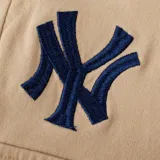 Pantalón cargo color beige de corte recto, con cintura elástica ajustable mediante cordón y bolsillos laterales amplios. Presenta un pequeño bordado del logotipo de los New York Yankees en la parte superior derecha.
