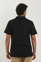 Chomba negra de piqué con cuello clásico y mangas cortas.