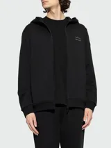Campera de algodón con capucha, cierre frontal completo y logo de la marca sutilmente estampado en el pecho. Diseño minimalista de corte estándar con puños y ruedo acanalados.