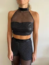 Top negro de red con cuello halter y detalles en charol.