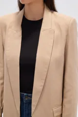 Blazer negro de corte holgado con cuello solapa y bolsillos frontales.