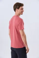 Remera de manga corta color borravino con cuello redondo y estampa frontal de una carpa junto a las inscripciones "Camp Explore Dream Discover" y "Adventure Outside Your Tent".