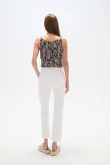 Pantalon jean de corte recto y tiro alto, color blanco, con ruedo deshilachado.