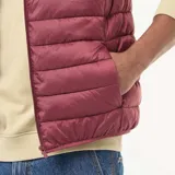 Chaleco acolchado tipo puffer en color bordó, con cierre frontal y cuello alto.
