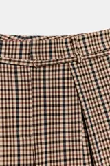 Pantalón de tiro medio con diseño de cuadros, corte amplio y pliegues frontales. Cuenta con bolsillos laterales ocultos, falsos bolsillos traseros y cinturón del mismo tejido incluido.