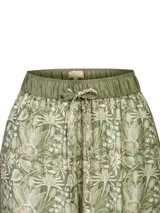 Pantalón fluido de pierna ancha, color verde militar, con estampado botánico y detalle de bandas laterales lisas. Cuenta con cintura elástica con cordón de ajuste.