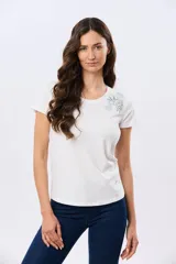 Remera blanca de manga corta y cuello redondo, confeccionada en algodón, con delicado bordado floral localizado en el hombro.