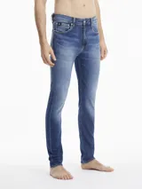 Jeans de calce slim, color azul, con pierna ajustada y tiro bajo.