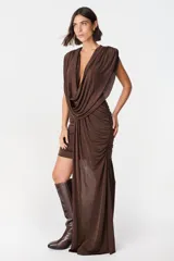 Vestido corto de diseño asimétrico en color verde oliva, con escote profundo en V, drapeado frontal y una caída lateral larga que llega hasta el suelo. Sin mangas y con ajuste entallado en la falda.