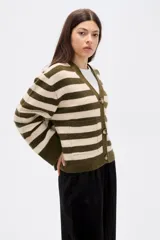 Saco tipo cárdigan de punto con diseño de rayas horizontales en verde oliva y beige. Presenta cuello en V, cierre frontal con botones, mangas largas holgadas y bolsillos frontales.