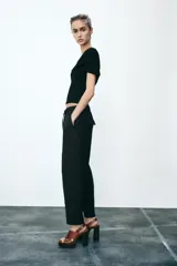 Pantalón tobillero color beige, con cintura elástica ajustable con cordones, bolsillos delanteros y falsos bolsillos con solapa en la espalda.