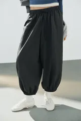 Pantalón de tiro medio y cintura elástica con cordón de ajuste, bolsillos laterales y bajo abullonado con puños elásticos. Confeccionado en poliamida.