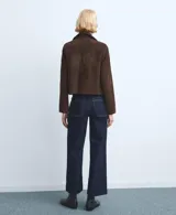 Jeans de corte recto y tiro medio en color azul oscuro, con costuras en contraste y acabado sin rematar en el ruedo.