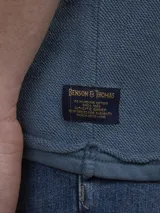 Buzo de tejido polar (fleece) color azul piedra, con cuello redondo y manga larga.