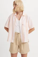 Camisa de manga corta Levi's con diseño de rayas verticales en tonos blanco y durazno. Presenta cuello clásico, cierre frontal con botones y un bolsillo en el pecho con la etiqueta roja característica de la marca.