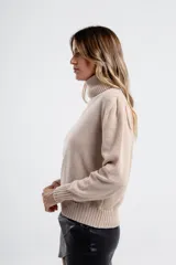 Polera de tejido de punto color negro, con cuello tortuga alto y puños y ruedo acanalados.