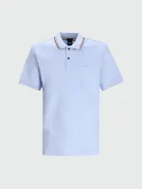 Polo de manga corta color celeste claro, corte slim fit, con cuello polo que presenta un ribete de rayas finas en tonos negro, beige y marrón. Tiene una tapeta de dos botones y el logo de la marca bordado sutilmente en el pecho.