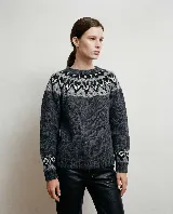 Buzo de tejido de punto con diseño de jacquard en el canesú y en los puños, de cuello redondo y manga larga.