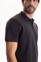 Chomba de piqué color blanco, con cuello polo y cierre frontal con tres botones.