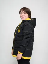 Campera gris con capucha y cierre frontal, con costuras horizontales y logo del Club Atlético Peñarol en el pecho.