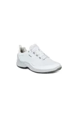 Championes deportivos blancos para mujer, con perforaciones en el cuerpo, sistema de cordones y suela gruesa en tonos de gris claro.