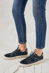 Jeans de denim azul oscuro, corte skinny y tiro medio.