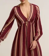 Vestido largo evasé de viscolino con 25% de lino, con escote en V, busto ajustado y mangas largas abullonadas. Diseño a rayas verticales en bloques de color bicolor.