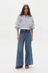 Pantalón de jean azul, de corte wide leg y tiro alto, con diseño clásico de cinco bolsillos y presillas para cinturón.