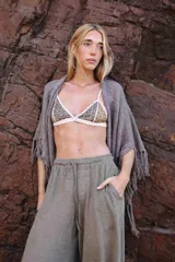 Capa tejida color negro, con flecos largos en los bordes.