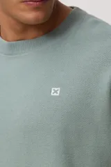 Sweater de punto de cuello redondo y manga larga, con diseño minimalista y logo pequeño bordado en el pecho.