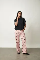 Camisa Girasol de manga corta color negro, con cuello camisero, cierre frontal de botones y mangas con volados drapeados.
