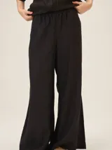 Pantalón de lino color tostado, de corte amplio y fluido con piernas acampanadas.