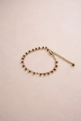 Pulsera de cadena dorada con dijes de piedras naturales y cuentas de colores. Presenta un diseño delicado con eslabones finos y cierre de mosquetón.