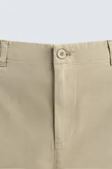 Pantalón de corte recto confeccionado en tejido de sarga con estructura diagonal. Presenta cintura elástica, bolsillos delanteros, bolsillos traseros de vivo y cierre frontal con cremallera y botón.