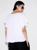 Remera blanca con rayas verticales finas en color gris, corte holgado y mangas cortas.