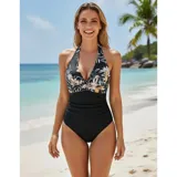 Malla entera de color verde oscuro, combinada con un diseño floreado en la parte inferior. Presenta escote halter cruzado y fruncidos en la zona del abdomen.