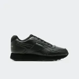 Championes Reebok Glide de color negro, confeccionados en cuero sintético, con diseño clásico de perfil bajo, cordones al tono y suela de goma amortiguada.