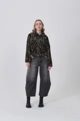 Campera de corderito con estampado animal print, de manga larga, cuello alto y cierre frontal completo.