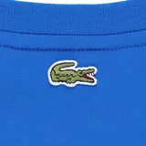 Remera Lacoste blanca de manga corta, confeccionada en algodón, con cuello redondo y pequeño estampado gráfico en el pecho.