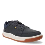 Championes urbanos Caterpillar modelo Apa Cush, color azul marino, confeccionados en gamuza con suela de goma bicolor blanca y marrón. Presentan cordones jaspeados y detalle de etiqueta pequeña en color amarillo.