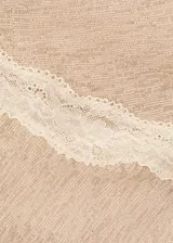 Top asimétrico de silueta slim, color beige, confeccionado con tejido ligero de textura plana y tirantes finos.