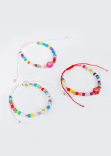 Pulsera elástica con mostacillas de colores y dije de emoji. Cordón ajustable.