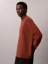 Sweater Calvin Klein de corte boxy y ajuste relajado, confeccionado en tejido de punto técnico. Presenta cuello semi alto y mangas largas con detalle de contraste en los puños.
