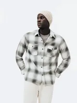 Camisa a cuadros de manga larga con dos bolsillos frontales con botón.