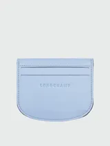 Tarjetero de cuero color celeste, modelo Le Pliage Xtra de Longchamp, con diseño abierto y bolsillos para tarjetas.
