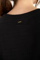 Remera color crema con textura de algodón peinado, poliéster y elastano, de corte recto y mangas cortas.