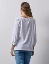 Blusa amarilla texturada con escote redondo y mangas 3/4 con puño elastizado. Aplique de broderie en escote y mangas. Marca Ruby Rd.