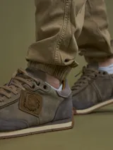 Pantalón cargo negro con bolsillos laterales con solapa, corte ajustado y tobillos elastizados.