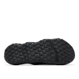 Sandalia tipo slide Columbia modelo Thrive Revive, color negro, diseñada para recuperación con entresuela de espuma ligera y suave. Presenta aberturas laterales para ventilación, plantilla hexagonal texturizada y suela de alta tracción para condiciones húmedas y secas.